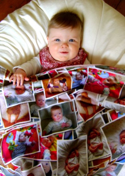 baby under blanket with photos