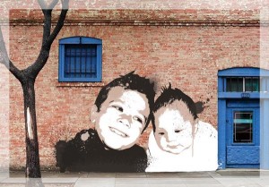 Two kids on brick wall in Banksy style artwork
