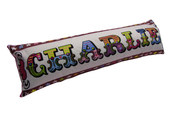 letters-sausage-cushion Sausage cushion with Charlie written on it in colourful letters