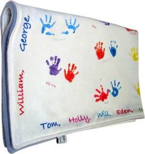 Fleece blanket with baby foot and handprints in colour on it