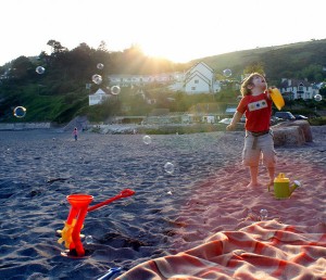 summer-fun-designers-choice-pic Boy blowing bubbles on a sunny beach