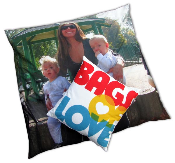 Mum with two kids on floor cushion and small cushion with bags of love written on it