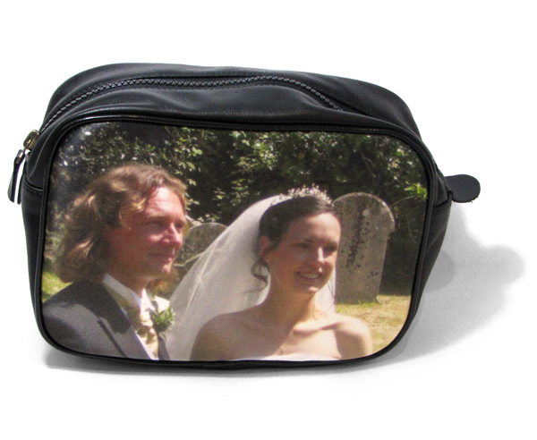 Man and women on their wedding day on a black leather wash bag