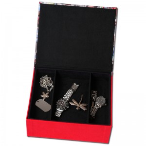 Open jewellery box with red exterior and black interior and mens jewellery pieces in it
