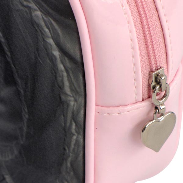 Silver heart on end of zipper on a pink make-up bag