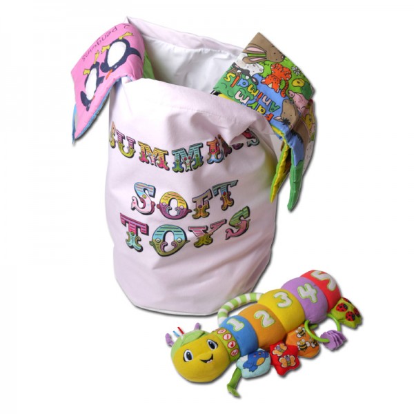 White toy bag with colourful writing on it and toys in it