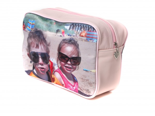 pink ladies wash bag Two kids on the beach wearing sunglasses on a pink washbag