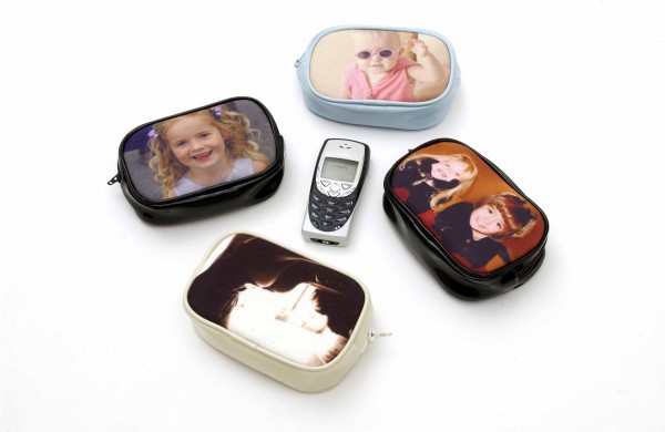 A mobile phone surrounded by four different purses with photos on