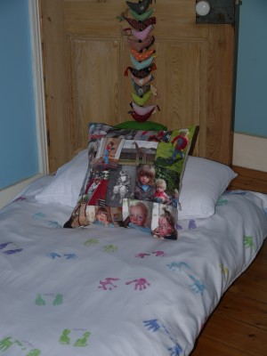 Bed with hand and foot prints duvet cover and photo montage cushion