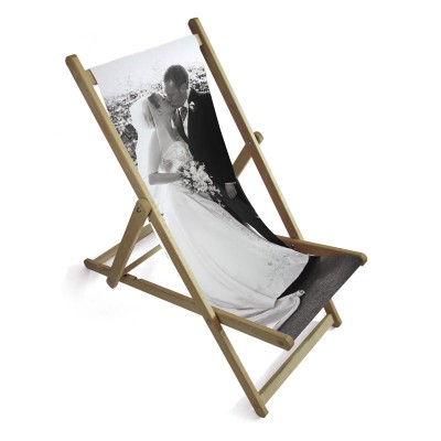 Personalised wedding deckchair A couple on their wedding day on the seat of a deckchair