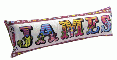 James written in colourful letters on a sausage shaped cushion