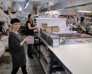 Women packaging jigsaw puzzles on table