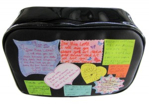 Black vinyl wash bag with coloured sticker notes with text