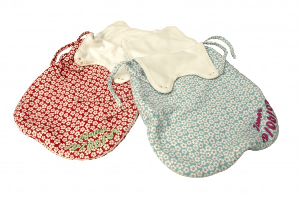 Two baby sleeping bags with patterns and text on