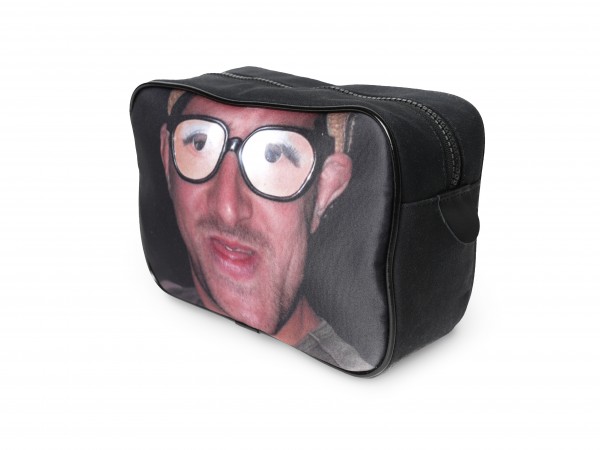 Man with glasses on a black canvas washbag