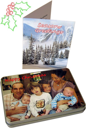 "Seasonal greetings" card next to a tin box with a family photo on the cover