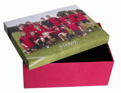 A group of boys in a football team on the lid of a box