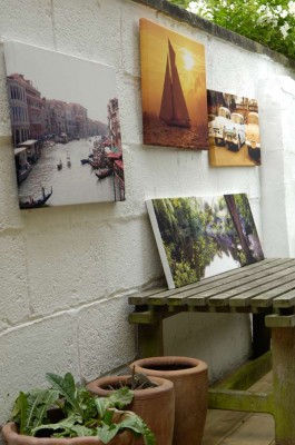 Canvas prints hanging on the wall of a patio