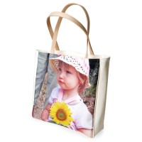 Little girl holding a sunflower on a shopper bag