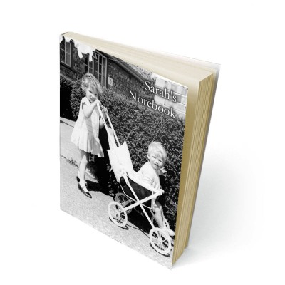 Two children in black and white on the cover of a notebook