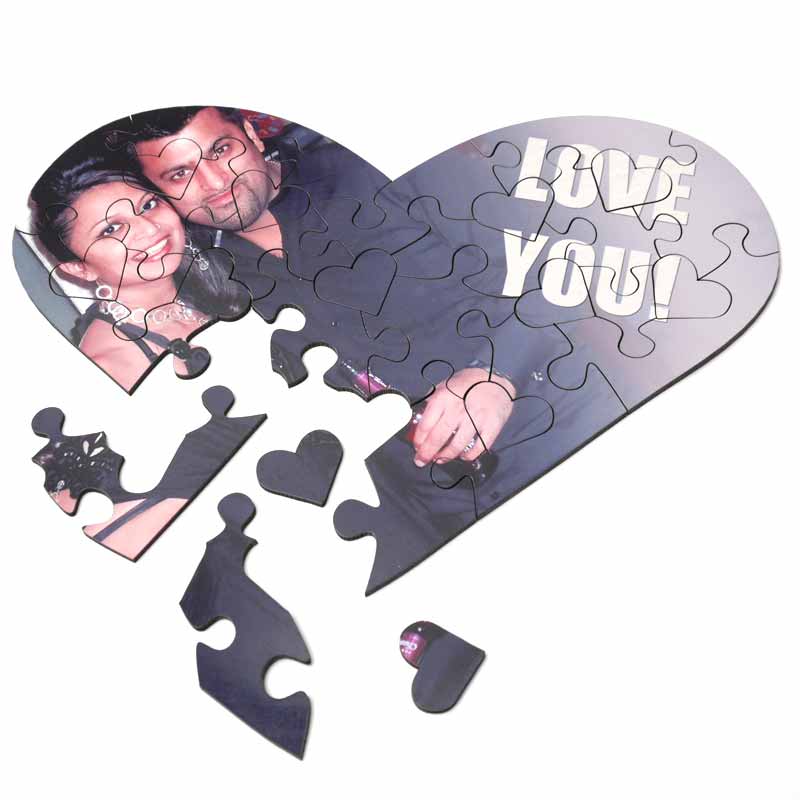 Man and woman and the text "Love you" on a heart shaped jigsaw puzzle