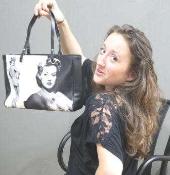 BagsofLove employee holding a photo handbag with a vintage movie design