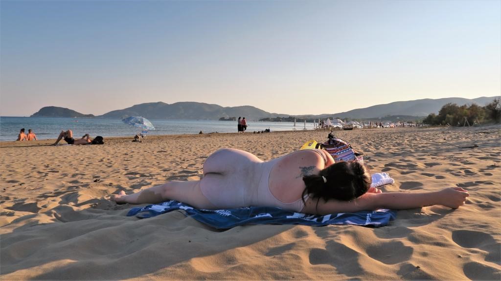 Rebekah lying on the beach with the customised costume on