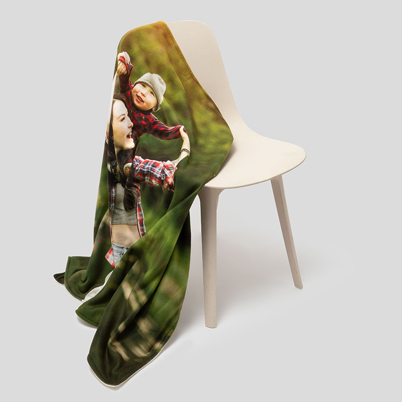 Custom photo blanket draped on chair